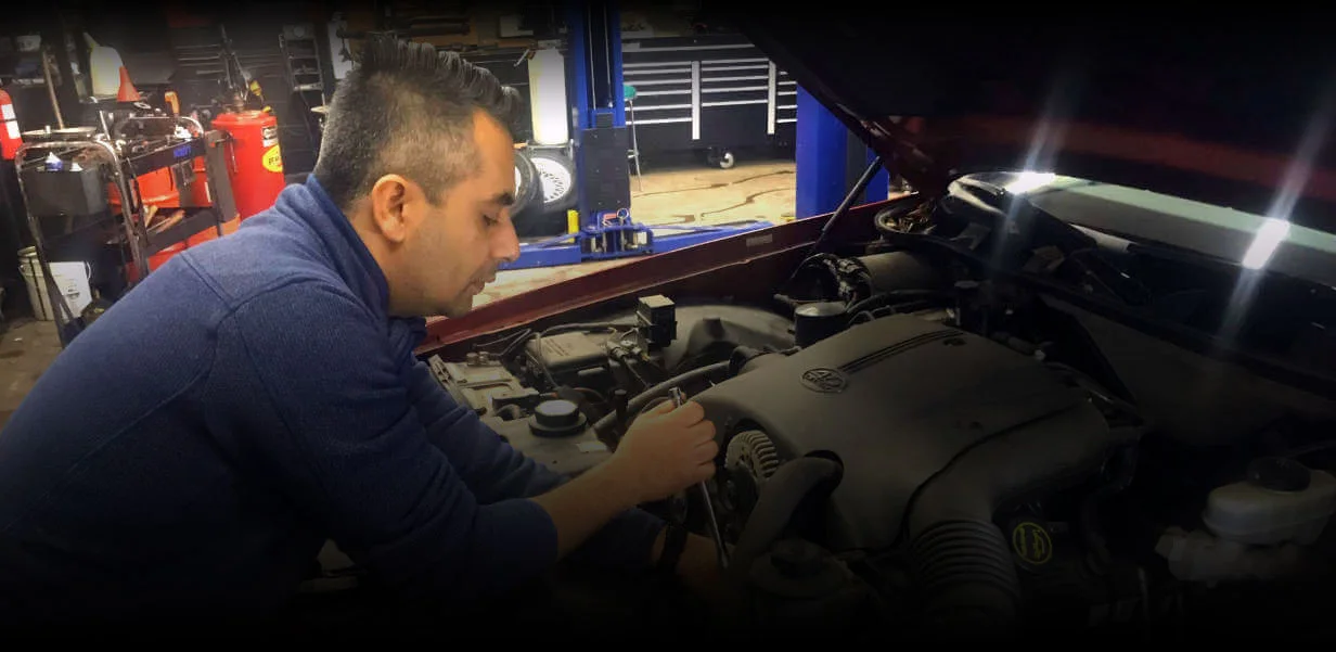 Robin working under the hood of a vehicle at SMRO